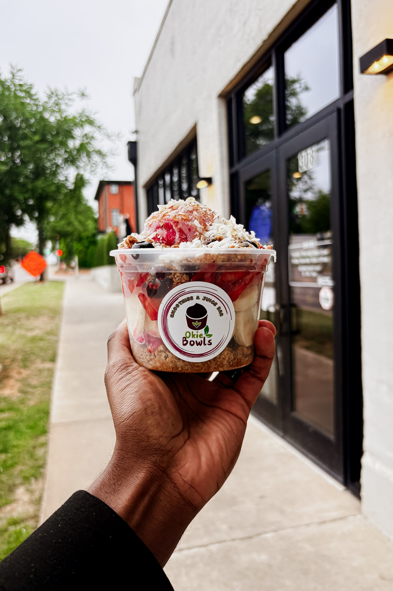 A freshly prepared Okie Bowls fruit bowl outside the shop